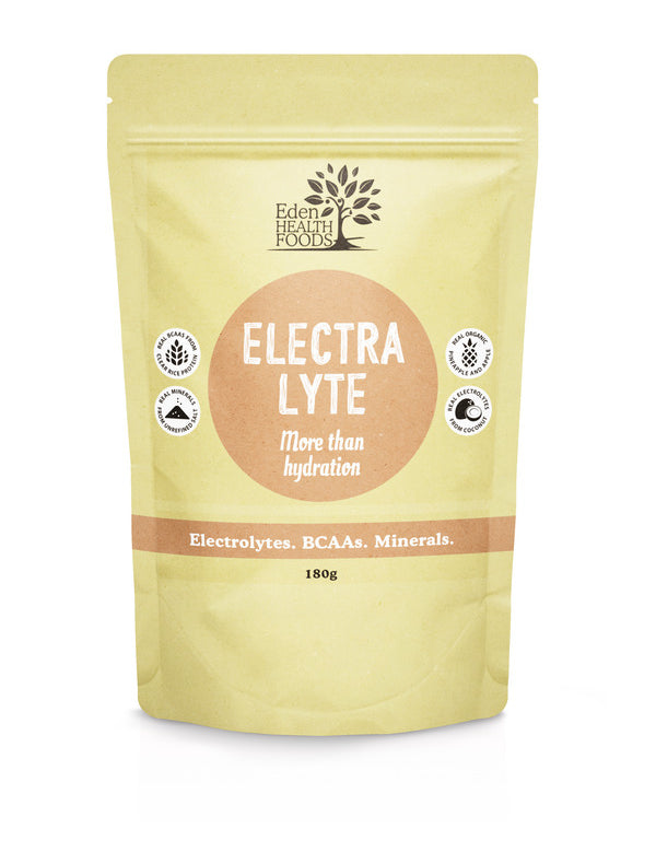 Pale yellow Eden Healthfoods Electra-Lyte Pineapple and Apple pouch standing upright, with a tan circular title panel and a horizontal band reading Electrolytes, BCAAs, Minerals.