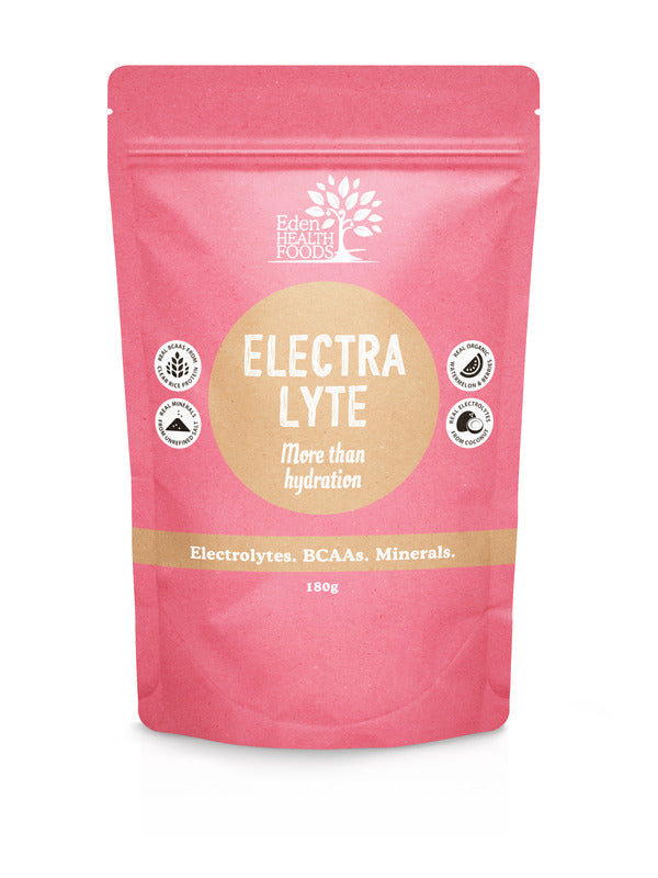 Coral-pink Eden Healthfoods Electra-Lyte Watermelon and Berry pouch standing upright, with a tan circular title panel, white lettering and four small black-and-white symbols.