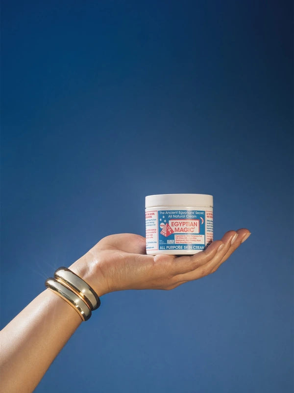 Egyptian Magic cream jar held against a blue sky