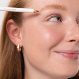 Model applying Ere Perez Almond Brow Pencil