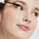 Model applying Ere Perez Avocado Waterproof Mascara