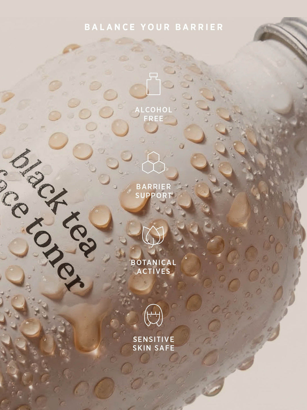 Water droplets on an Ere Perez Black Tea Face Toner bottle beneath icons labelled alcohol free, barrier support, botanical actives and sensitive skin safe.