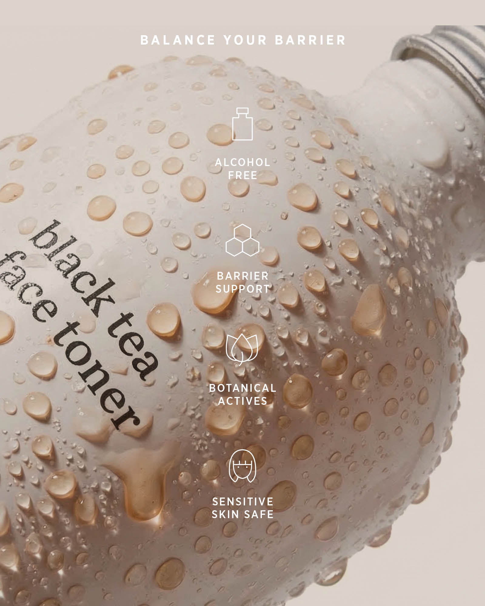 Water droplets on an Ere Perez Black Tea Face Toner bottle beneath icons labelled alcohol free, barrier support, botanical actives and sensitive skin safe.