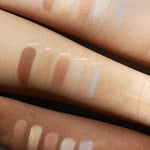 Ere Perez Light Shimmer eyeshadow swatches on three forearms with light, medium and deep skin tones. Lustre, Ray, Ember, Twilight and Moon show bronze, gold, rosy copper, pearl and cool silver finishes.