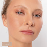 Blonde model wearing a soft pearly and bronze eye look from the Ere Perez Light Shimmer palette, with Twilight and Lustre shade swatches at the lower left.
