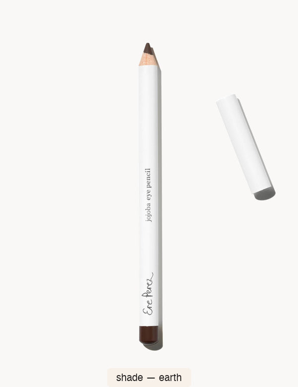 White Ere Perez Jojoba Eye Pencil in Earth, with an exposed dark brown tip, a matching brown end cap and its white lid beside it; the shade name appears below.
