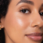 Model wearing Ere Perez Natural Almond Mascara for naturally defined lashes