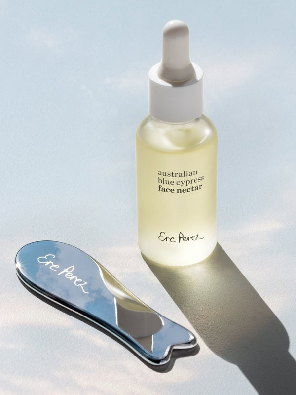 Ere Perez Self-Care Duo – face nectar and steel face tool in sunlight
