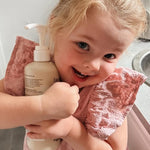 Smiling child holding Euclove Laundry Wash