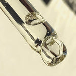 Close-up of the Ere Perez Australian Blue Cypress Face Nectar dropper with golden drops of facial oil