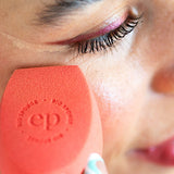 Woman blending makeup under her eye with an Ere Perez Bio All-Beauty Sponge
