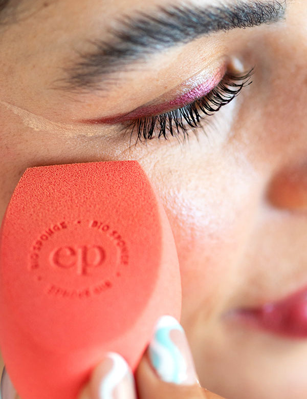 Woman blending makeup under her eye with an Ere Perez Bio All-Beauty Sponge