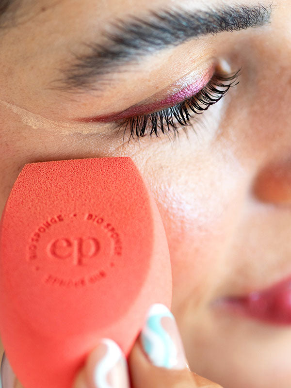 Woman blending makeup under her eye with an Ere Perez Bio All-Beauty Sponge