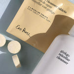 Ere Perez Ginkgo Micellar Cleanser tablet sachet with loose tablets and the bottle on a soft blue surface