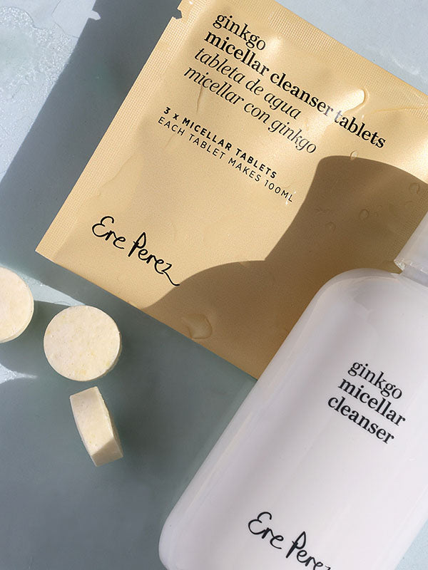 Ere Perez Ginkgo Micellar Cleanser tablet sachet with loose tablets and the bottle on a soft blue surface
