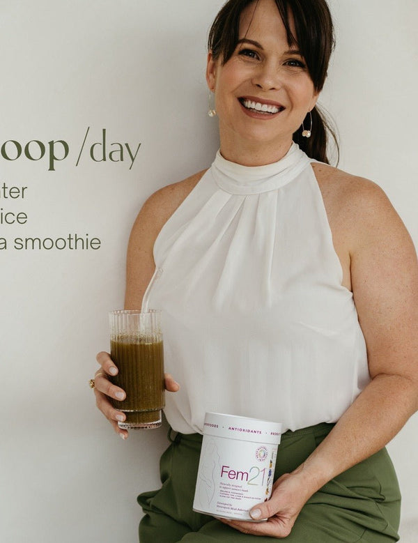 Woman holding Natural Health by Meah Fem21 and a prepared green drink