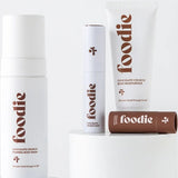 Vanessa Megan Foodie Chocolate Crunch four-piece Body Bundle: foaming body wash, body moisturiser, face and body mist, and lip balm arranged on white display plinths.