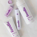 Vanessa Megan Foodie Passion Pop four-piece Body Bundle: foaming body wash, body moisturiser, face and body mist, and lip balm arranged on softly folded white fabric, with the lip balm open.