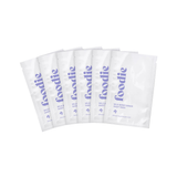 Foodie Wild Berry Dream Sheet Mask 6-Pack, showing six white individual sachets arranged in a fan, with purple Foodie logos and Wild Berry Dream labels on a plain white background.
