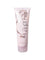 A pink 8 fl oz (236 ml) tube of 100% Pure Glossy Locks Glossing Conditioner with a floral design and black text. Enriched with biotin and coconut oil for glossy, hydrated hair. Bottom cap for easy dispensing.