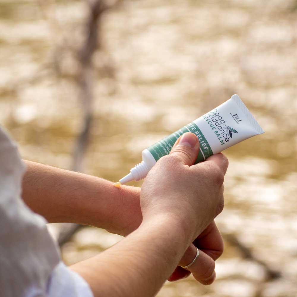 Good Riddance Rescue Balm being applied outdoors