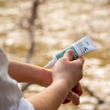 Good Riddance Rescue Balm being applied outdoors
