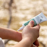 Good Riddance Rescue Balm being applied outdoors