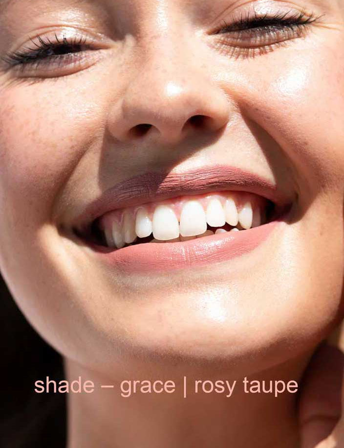 Close-up of a smiling person with text 'shade - grace | rosy taupe' at the bottom.