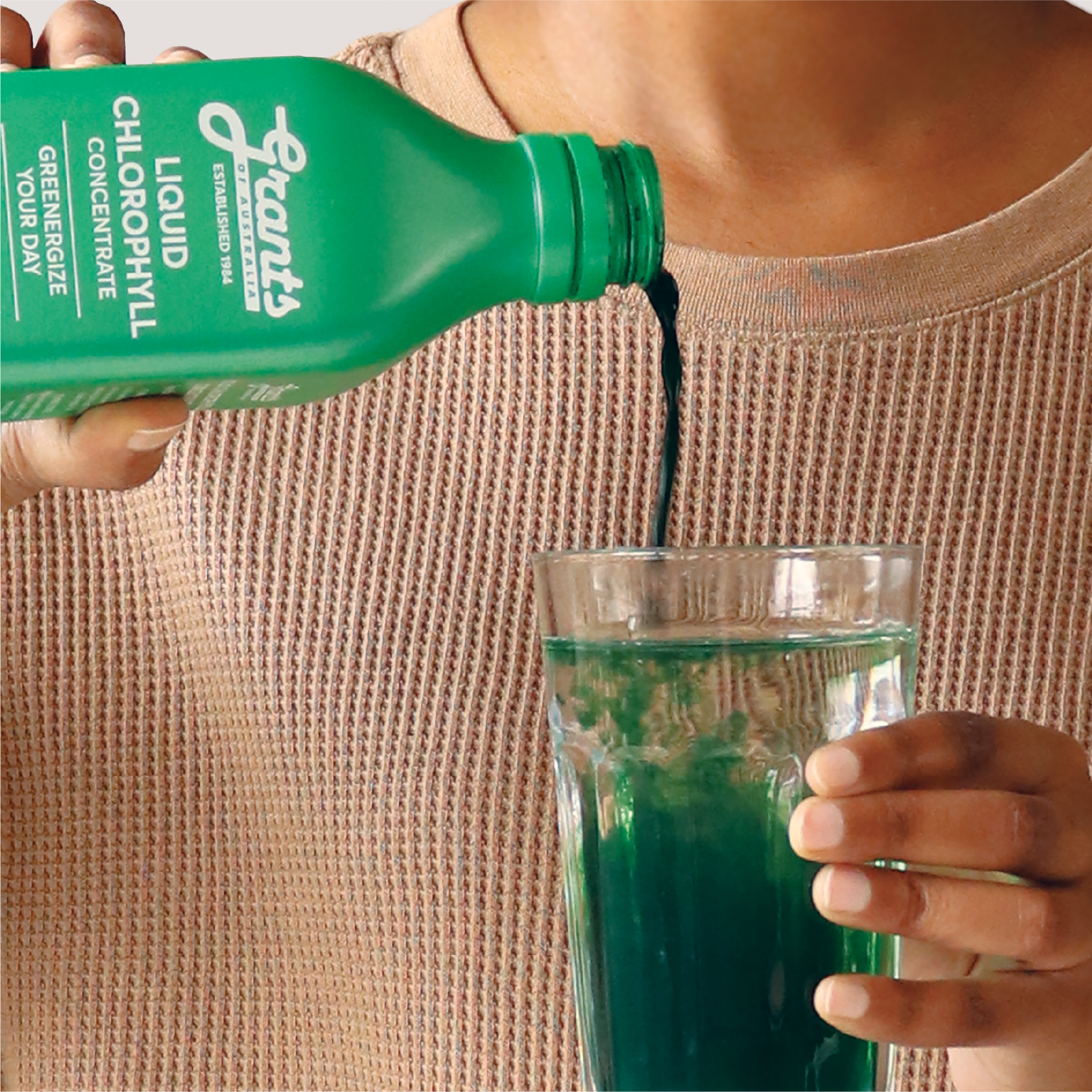 Grants Liquid Chlorophyll being poured into a glass of water