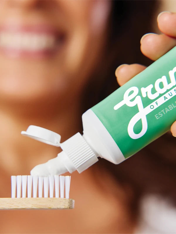 Grants Mild Mint toothpaste applied to a bamboo toothbrush