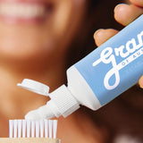 Grants Whitening plus HA toothpaste applied to a bamboo toothbrush