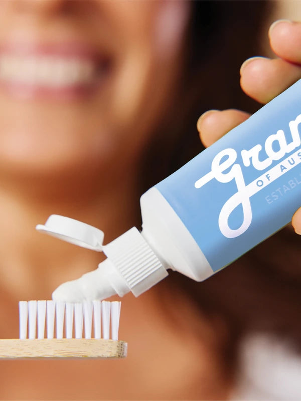 Grants Whitening plus HA toothpaste applied to a bamboo toothbrush