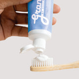 Grants Whitening plus HA toothpaste being squeezed onto a bamboo toothbrush