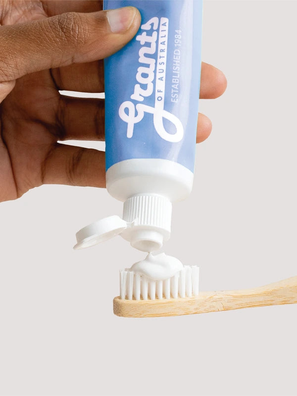 Grants Whitening plus HA toothpaste being squeezed onto a bamboo toothbrush
