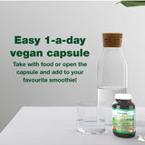 Green Nutritionals Vegan Multivitamin beside a glass of water