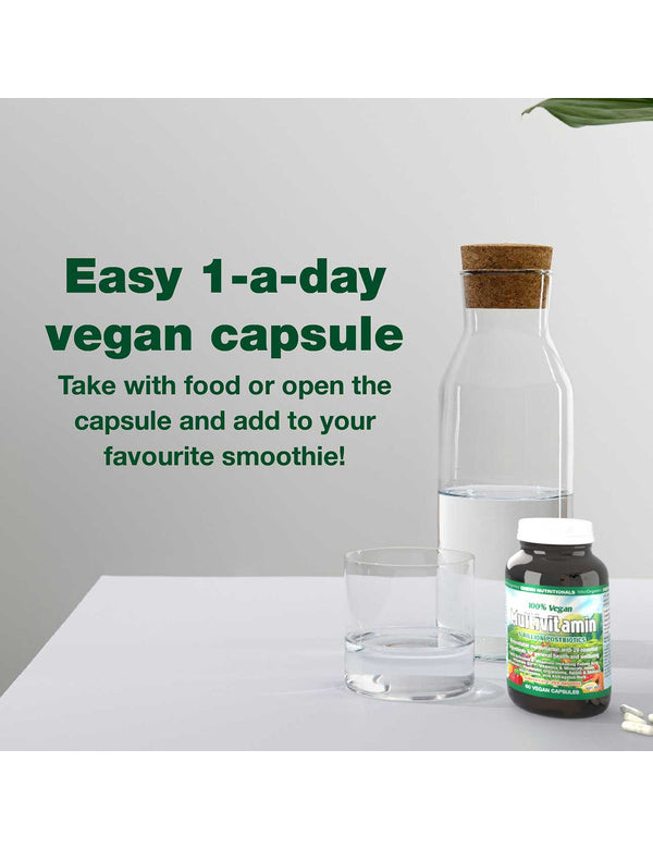 Green Nutritionals Vegan Multivitamin beside a glass of water