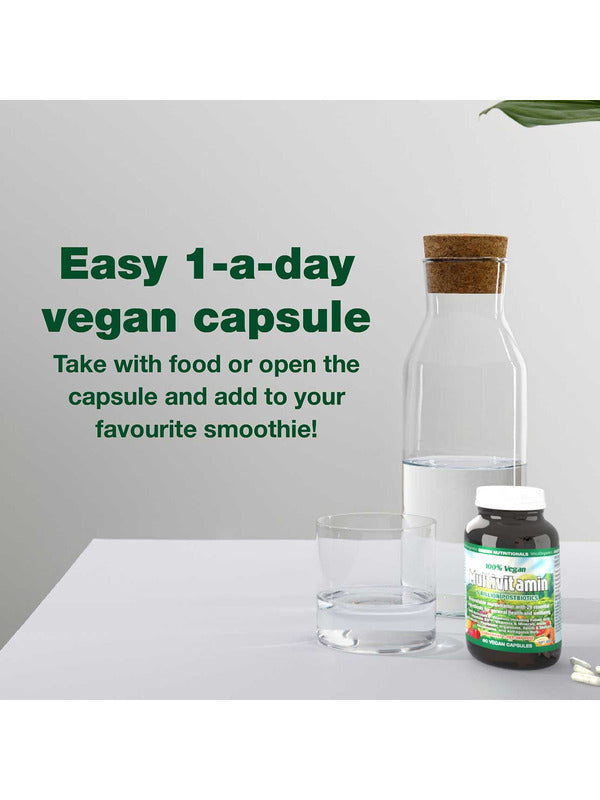 Green Nutritionals Vegan Multivitamin beside a glass of water