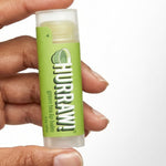 Hand holding Hurraw! Organic Lip Balm - Green Tea 4.8g