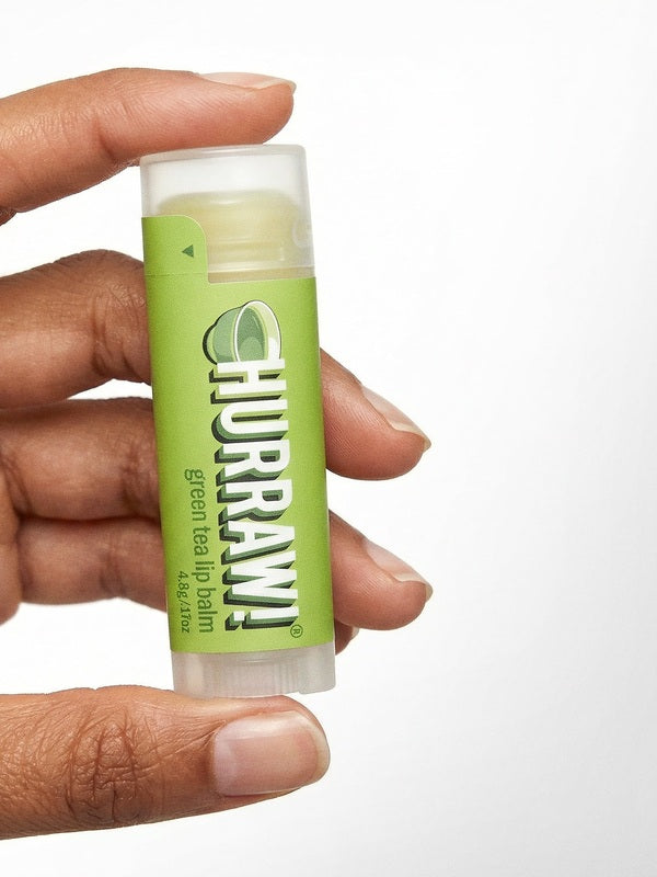 Hand holding Hurraw! Organic Lip Balm - Green Tea 4.8g