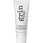 White Grin Pro Enamel Care toothpaste tube standing on a white cap, with large dark blue Grin Pro lettering running vertically down the front.