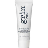 White Grin Pro Enamel Care toothpaste tube standing on a white cap, with large dark blue Grin Pro lettering running vertically down the front.