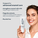 Smiling woman holding Grin Pro Enamel Care Toothpaste