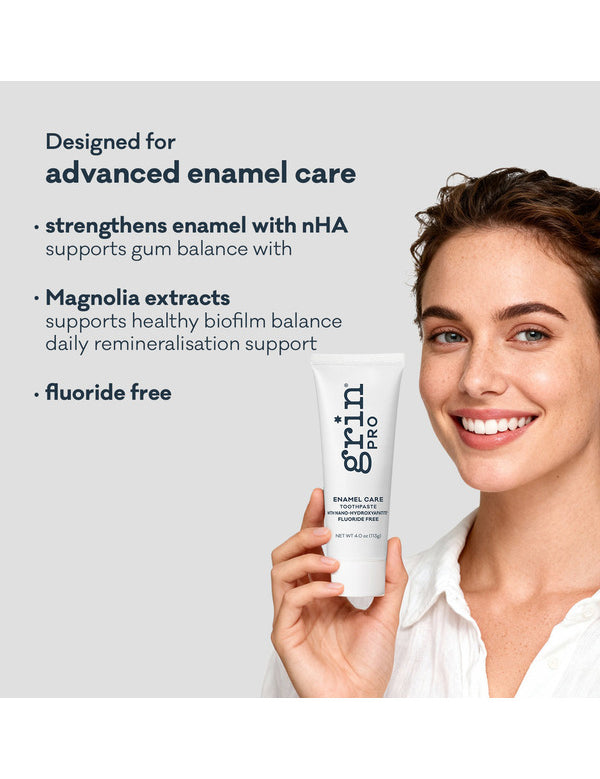 Smiling woman holding Grin Pro Enamel Care Toothpaste