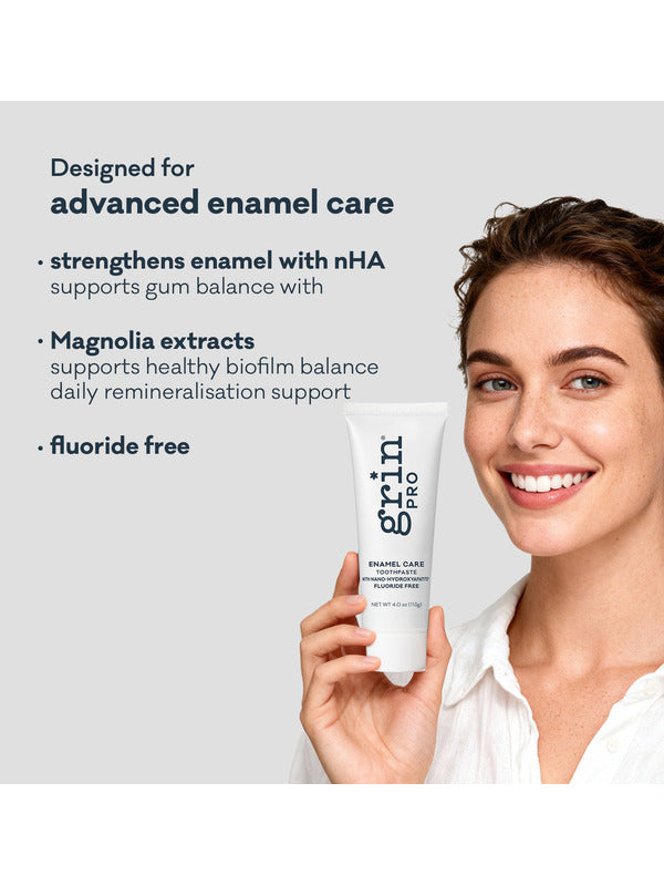 Smiling woman holding Grin Pro Enamel Care Toothpaste