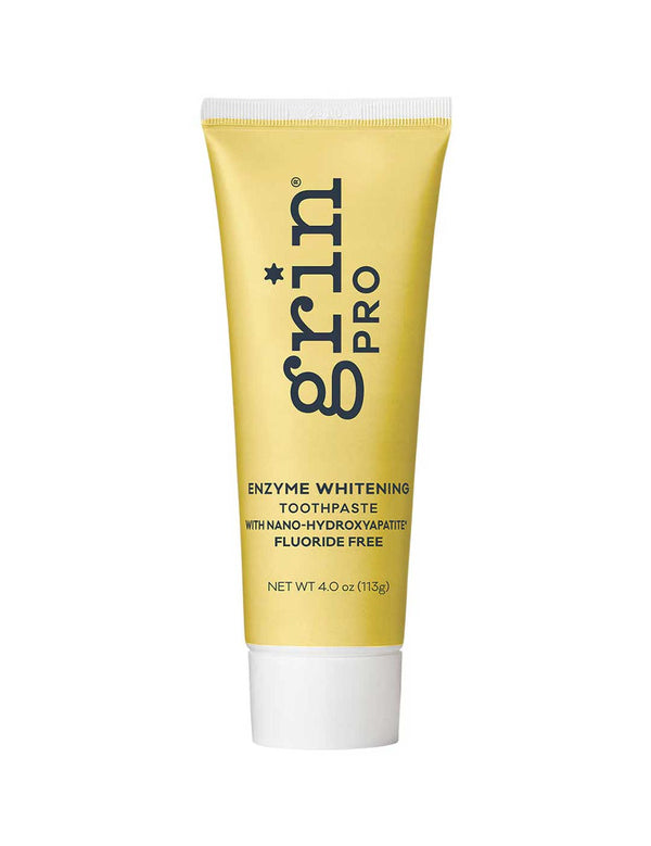 Yellow tube of grin Pro enzyme whitening toothpaste on a white background