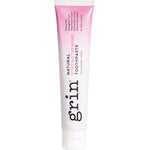 Grin Natural Strengthening toothpaste tube with a pink-to-white gradient, dark vertical Grin lettering and a white flip-top cap.