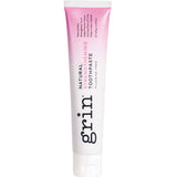 Grin Natural Strengthening toothpaste tube with a pink-to-white gradient, dark vertical Grin lettering and a white flip-top cap.