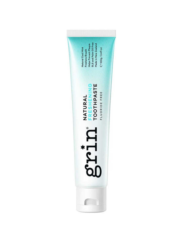 Grin Natural Freshening toothpaste tube with a turquoise-to-white gradient, black vertical Grin lettering and a white flip-top cap.