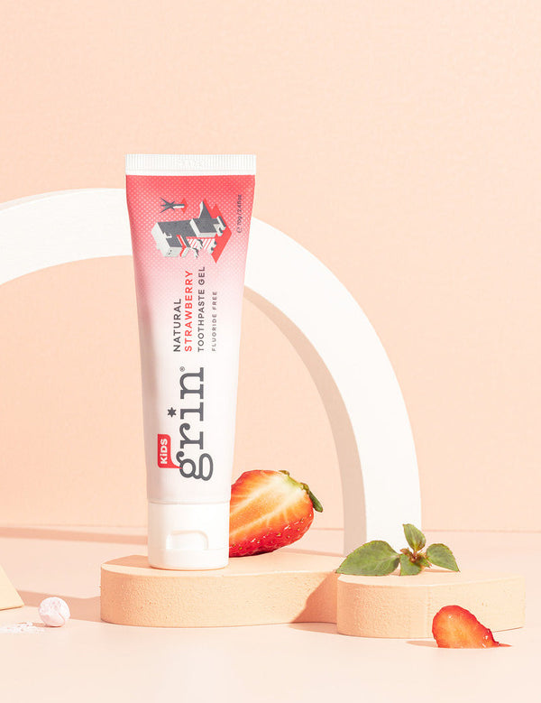Grin Kids Strawberry Toothpaste styled with strawberries