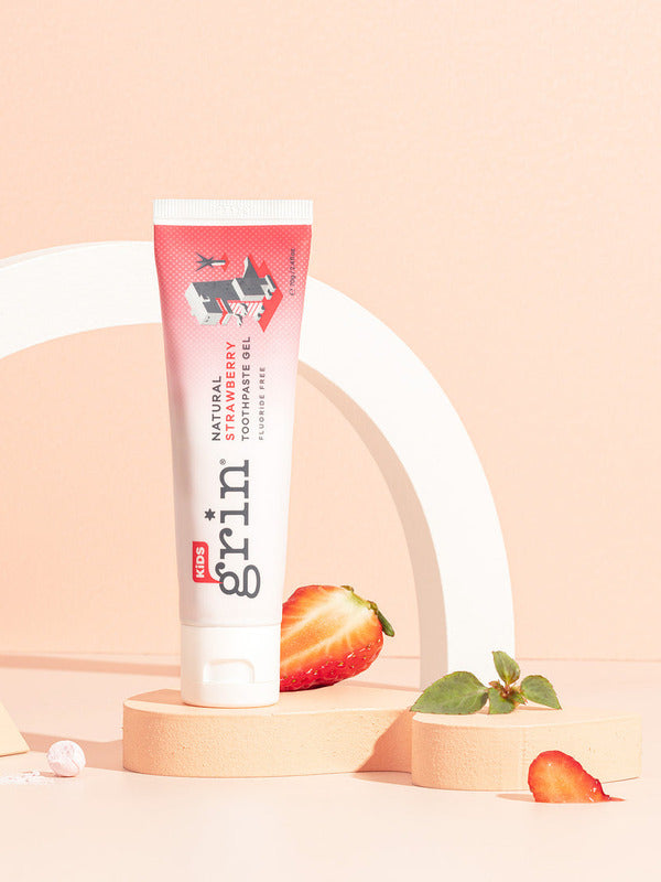 Grin Kids Strawberry Toothpaste styled with strawberries